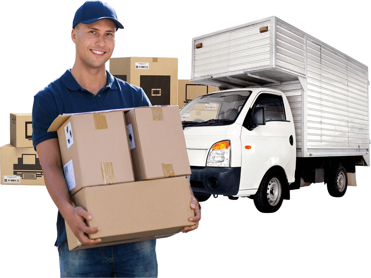 A man holding boxes in front of a moving truck, preparing for his move to a new home.